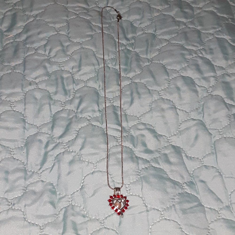 Necklace with a pearl in it.